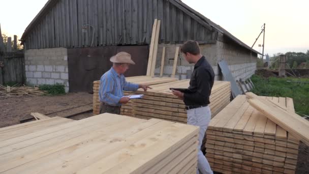 Worker And Businessman At Sawmill, Check Count Visiting Packed By Wooden Boards. — Stock Video