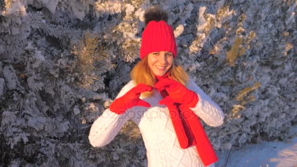 Mujer encantadora sonriendo con las manos haciendo corazón en invierno cuento al aire libre 4K — Vídeos de Stock