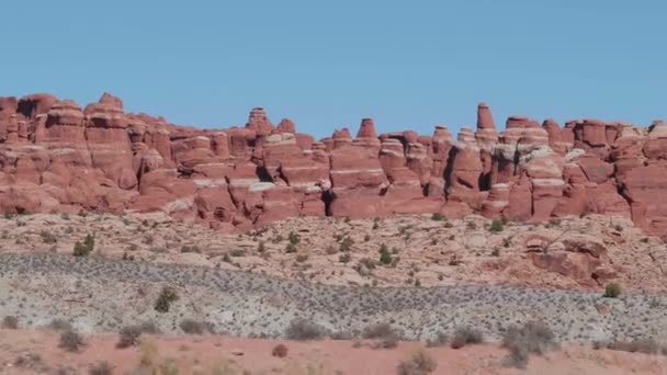 Πυρκαγιά κόκκινο μαζικό βράχο πυραμίδες σχηματισμός σε καμάρες πάρκο την ηλιόλουστη μέρα σε κίνηση — Αρχείο Βίντεο
