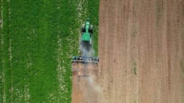 Traktör, Ekin Havası 'nın tepesini dikmeden önce Yeşil Tarım Alanını Sürüyor