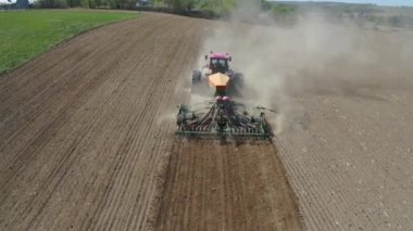 Tractor With Seeder Plant Seeds Of Corn In Dust Agricultural Field Aerial