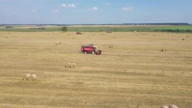 Agricultural Combines Harvest Ripe Wheat Crops On Rural Field Aerial Side View