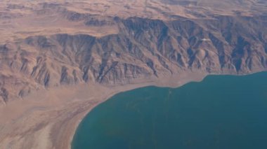 View From Plane To Seashore Or Lake With Turquoise Water In Desert With Rocks
