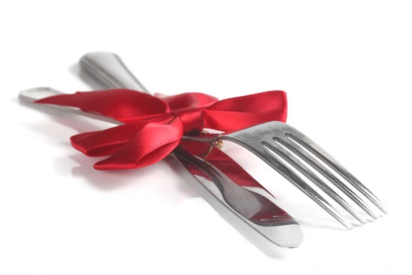 Fork and knife with christmas ribbon, isolated on white, shallow Royalty Free Stock Photos