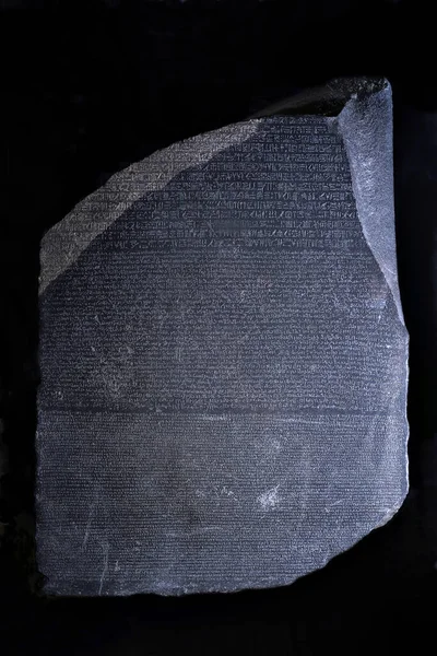 Rosetta Stone 'un kopyası, siyah bir arka planda izole edilmiş, yüzeysel bir odak.