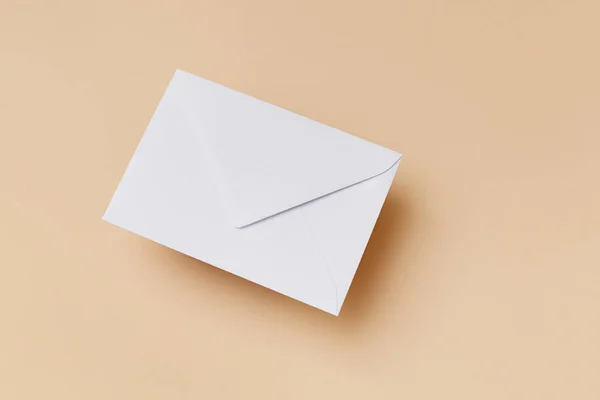 White envelope on the biege background. Mail concept — Stock Photo, Image