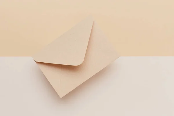 Biege envelope on the biege double colored background. Mail concept — 스톡 사진