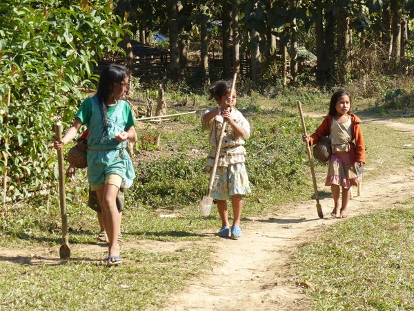 Group of young girls walking through the forest going back home in Laos. January 2015. — Stock Photo, Image