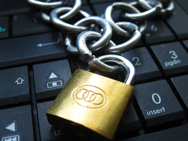 Chain and lock on laptop keyboard. Computer ban, internet ban. Addiction. Anti virus