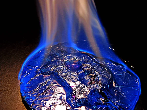 Bitcoin on fire. Real coin is burning with blue flame as symbol of hot price or critical fall — Stock Photo, Image