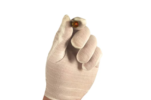 Hand in white glove holds one bullet in fingers. Isolated closeu — Stock Photo, Image