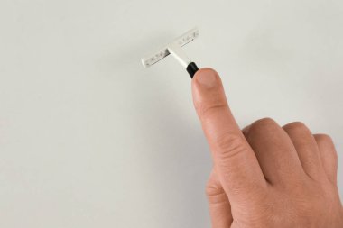 Man hand holds shaving stick. Mock-up on light background with s