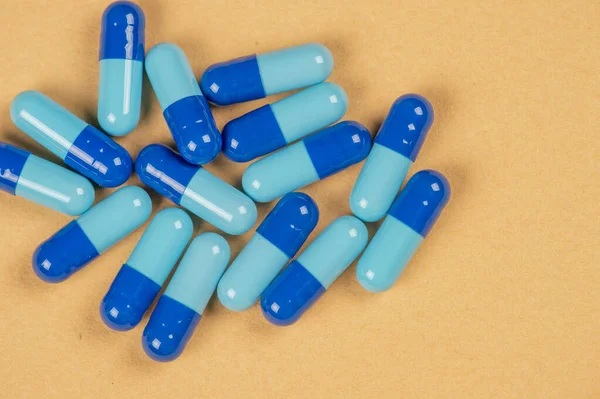 Таблетки капсулы и два оттенка синего — стоковое фото