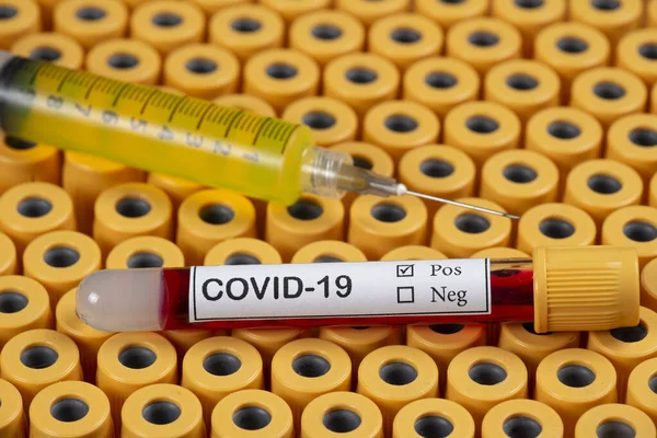 blood sample for COVID-19 on the tube tray and an injection syringe