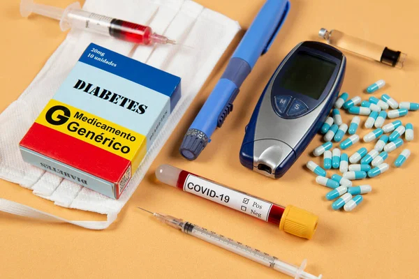various elements of medicine on a orange background and a tube of blood test for covid-19. Box write Diabetes and generic Drug in Portugues