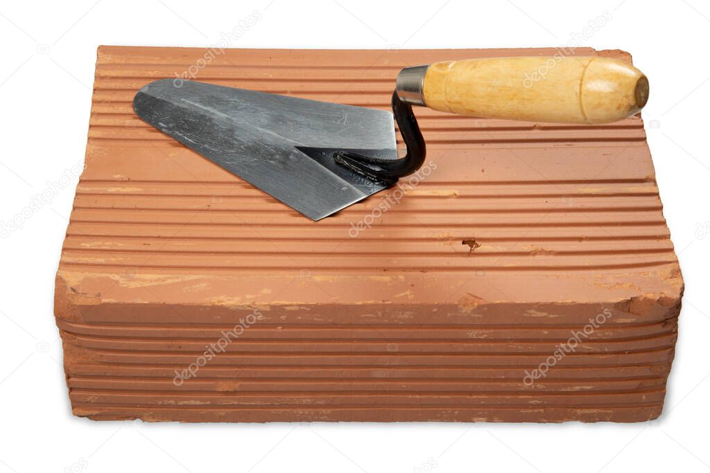 Construction Trowel over a brick in a white background. Up view