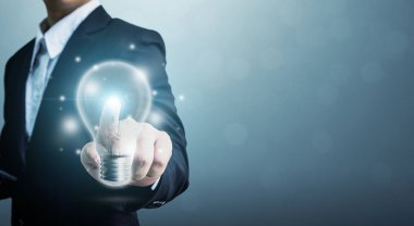 The power of creativity, technology, innovation or new business to success in the future concept, Businessman hand touching light bulb