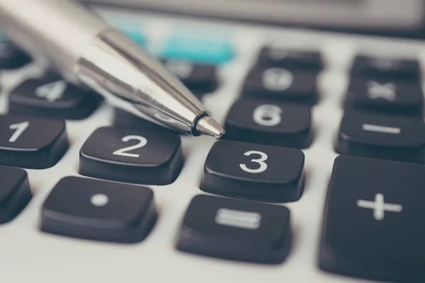 Calculator and pen. Finance and money investment concept