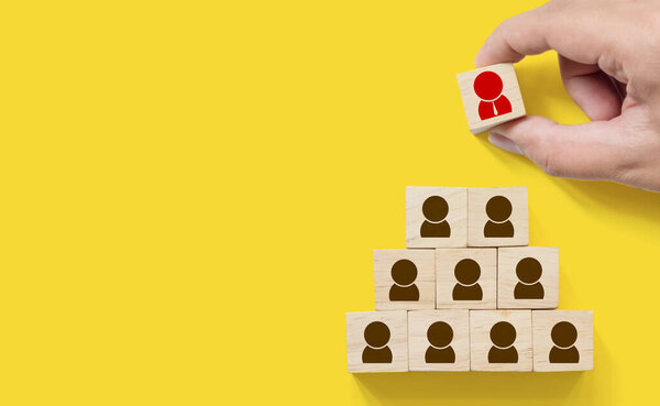 Human resource management and recruitment business concept, Hand putting wood cube block on top pyramid, Copy space