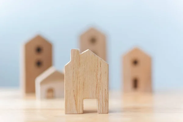 Real estate developer and managing property investment concept. Selective focus wooden houses on table