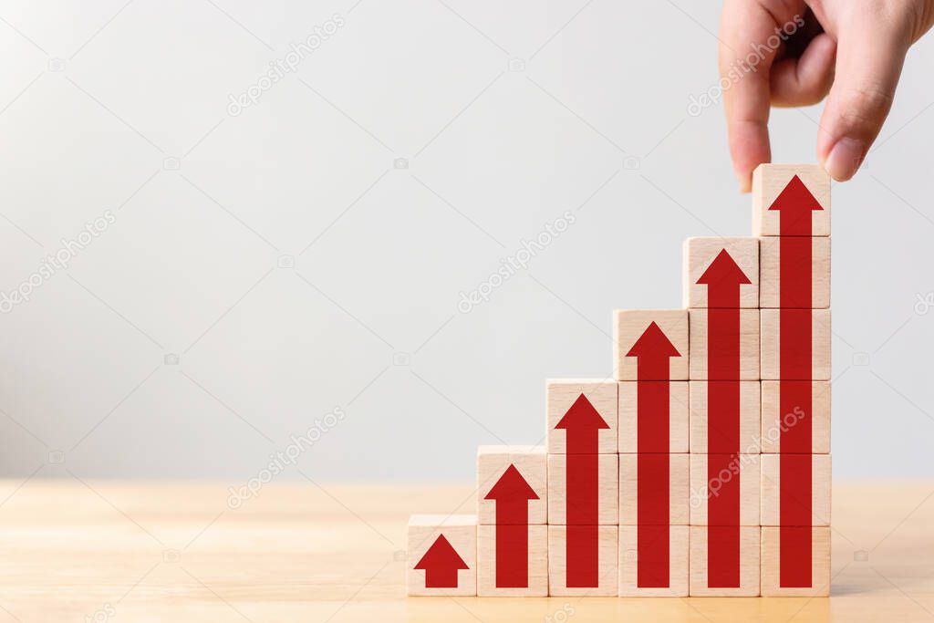 Ladder career path for business growth success process concept.Hand arranging wood block stacking as step stair with arrow up