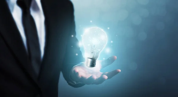 The power of creativity, technology, innovation or new business to success in the future concept, Businessman holding light bulb
