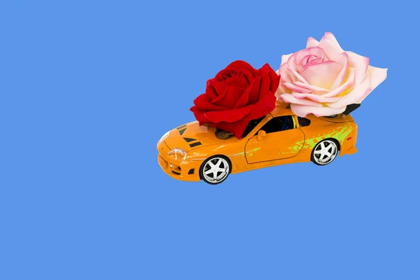 toy car with roses on blue background