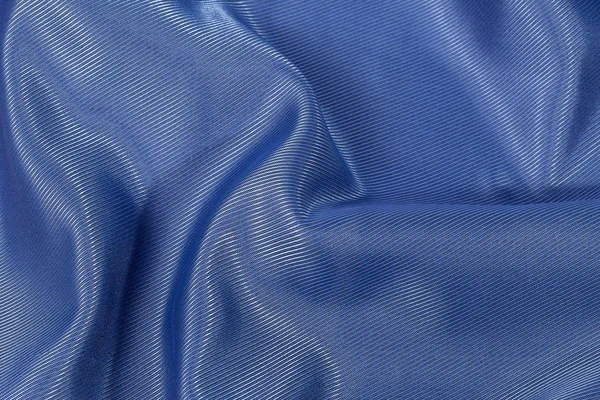 Silk bakgrund, textur av blå glänsande tyg, närbild — Stockfoto