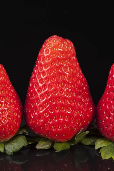 Fresh fruits of red strawberry isolated on black background — Stock Photo, Image