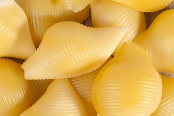Makaron Conchiglie, tło muszelek, zbliżenie — Zdjęcie stockowe