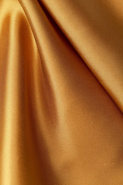 シルクの背景、黄色の光沢のある生地の質感をクローズ アップ — ストック写真