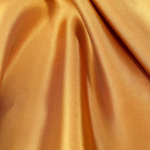 シルクの背景、黄色の光沢のある生地のテクスチャ — ストック写真