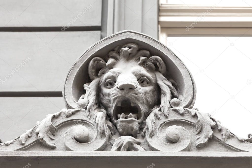 Relief on facade of old building, stone lion, Prague, Czech Republic.