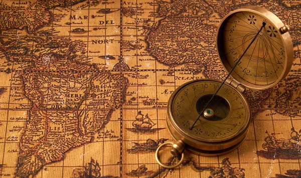 Old vintage retro compass on ancient world map. Vintage still life. Travel geography navigation concept background. — Stock Photo, Image