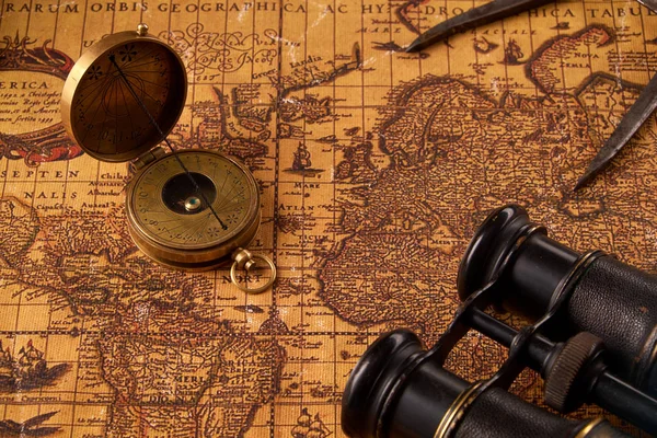 Old vintage retro compass on ancient world map. Vintage still life. Travel geography navigation concept background. — Stock Photo, Image
