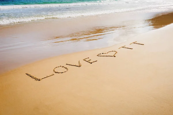 Word Love TT Trinidad and Tobago written on the beach sand in Maracas Bay Beach — Stock Photo, Image