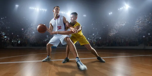 Basketball players on big professional arena