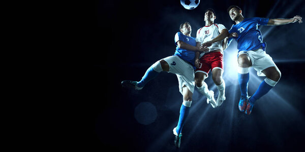 Soccer players performs an action play on a professional stadium