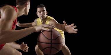 Basketball players on a black background clipart