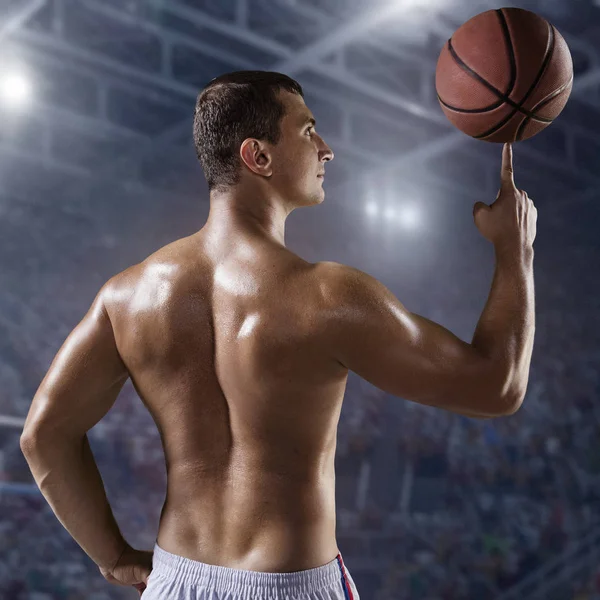 Basketball player hold a ball on professional arena