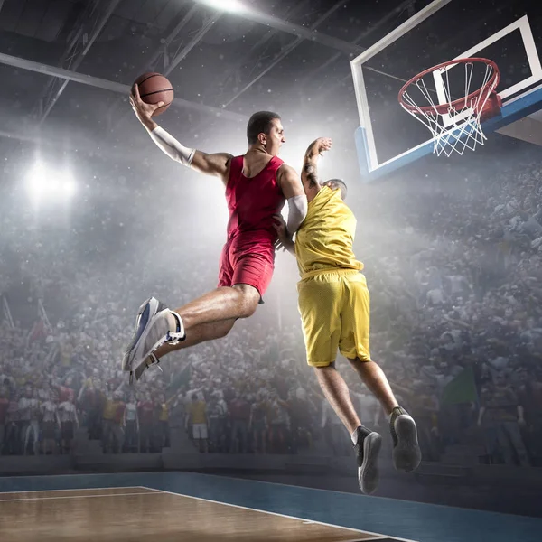 Basketball players on big professional arena makes slam dunk