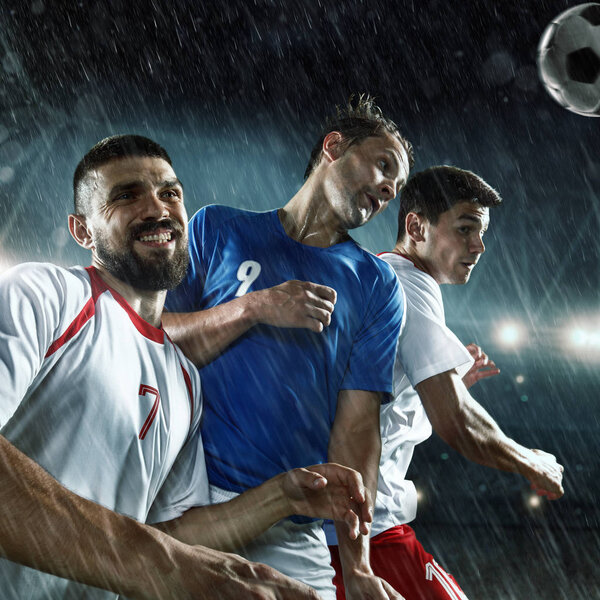 Soccer players performs an action play on a professional stadium