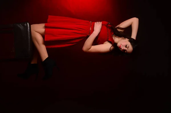 Sensual beautiful blonde woman posing in red dress. Girl with long curly hair. — Stock Photo, Image