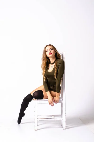 Young sexy woman sitting on chair. — Stock Photo, Image