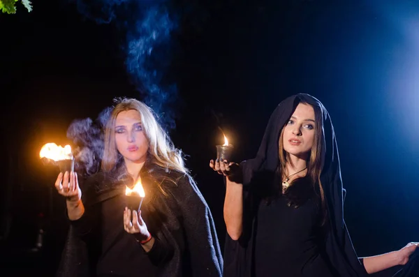 黒い服を着た謎の少女たちたき火のそばの森の中の魔女の安息日 — ストック写真
