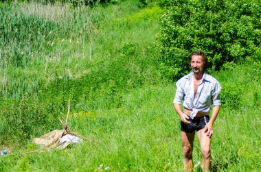 man resting outside the city on the beach