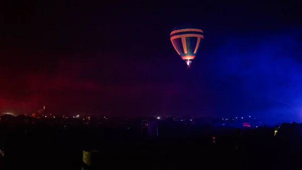 Balão de ar quente voando sobre a espetacular Capadócia sob o céu com forma leitosa e brilhante estrela à noite (com grãos ) — Fotografia de Stock