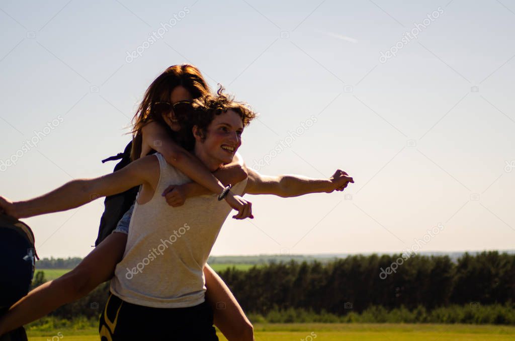 backpackers man and girl on the field