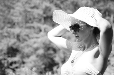 Şapkalı kız güneşli göl sahillerinde vakit geçiriyor. 