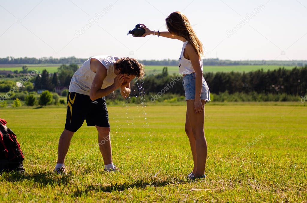 backpackers man and girl on the field